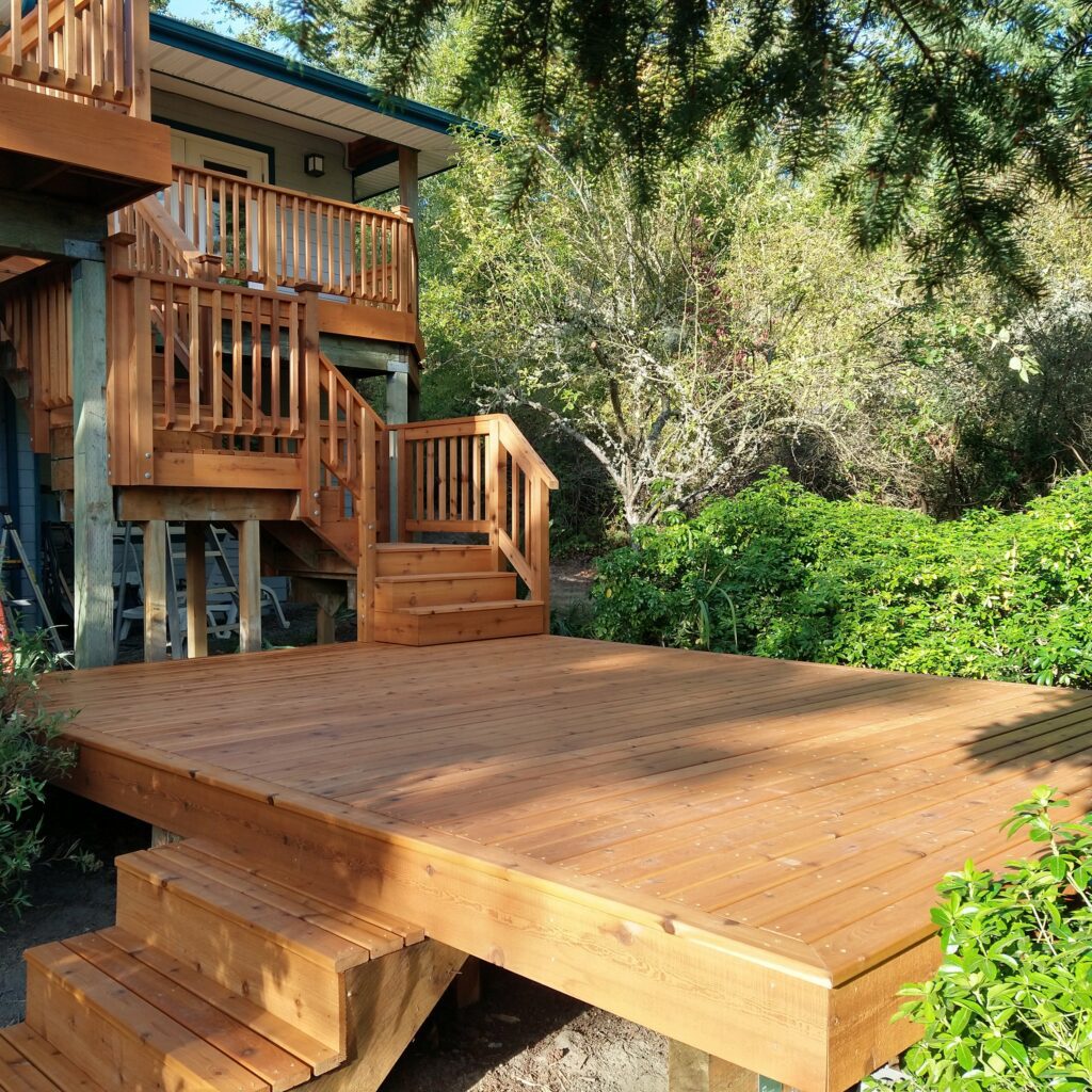 A Deck With Stairs And Trees In The Background